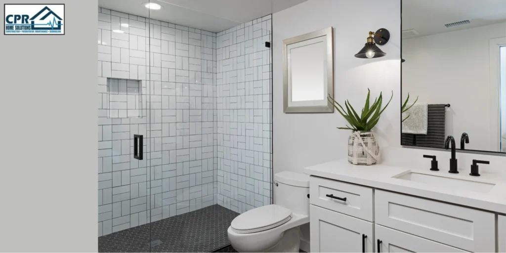 Modern small bathroom design ideas featuring a glass walk-in shower, white subway tiles, and a sleek vanity with black fixtures for a clean, space-saving layout