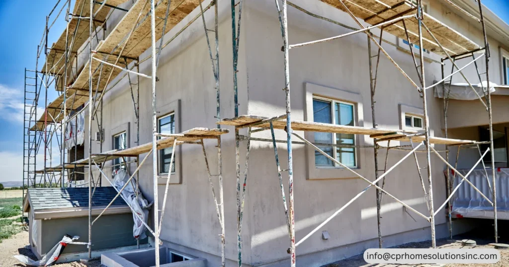 Exterior renovation work with scaffolding around multi-story house with Exterior Home Improvement Services, including stucco repair, siding installation, home remodeling and residential construction. 