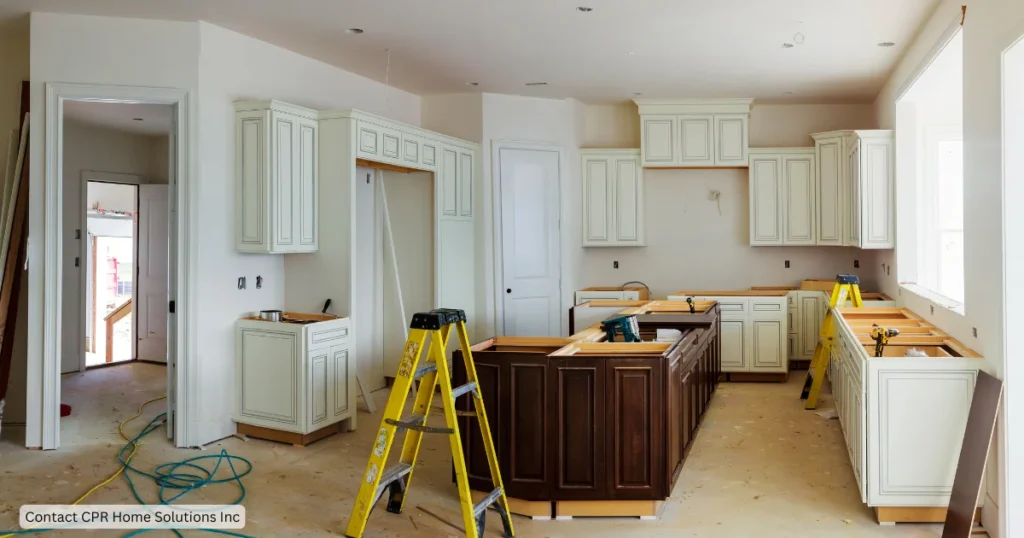 Partially finished kitchen with new cabinets, ladders and unfinished countertops, important steps in a kitchen remodel including kitchen design, cabinet fitting and renovation preparation. 