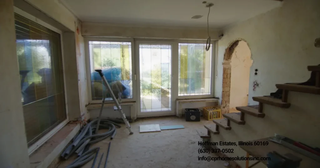 Office interior under renovation with exposed flooring, construction materials, staircase and big windows. Work of an Office Renovation Contractor that specializes in commercial remodeling and workspace transformation. 