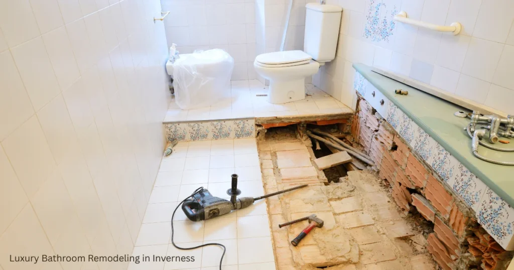 Bathroom renovation being performed by workers with exposed flooring, plumbing and construction materials, illustrating the works of luxury home remodeling contractors.