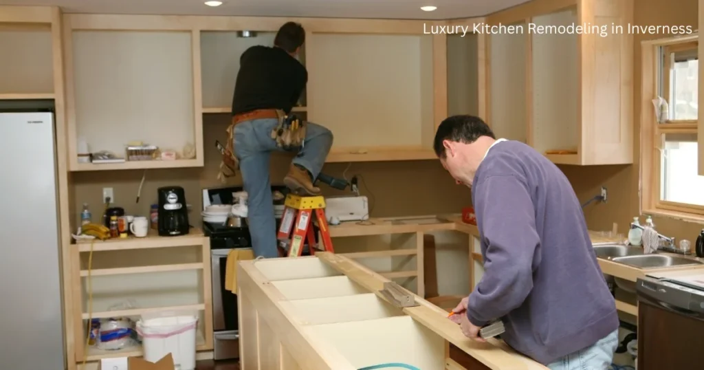 Contractors at work installing cabinets and fixtures in partly renovated kitchen, illustrating the works of luxury home remodeling contractors.